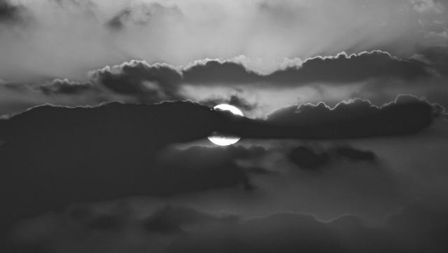Moon through broken cloud, black and white